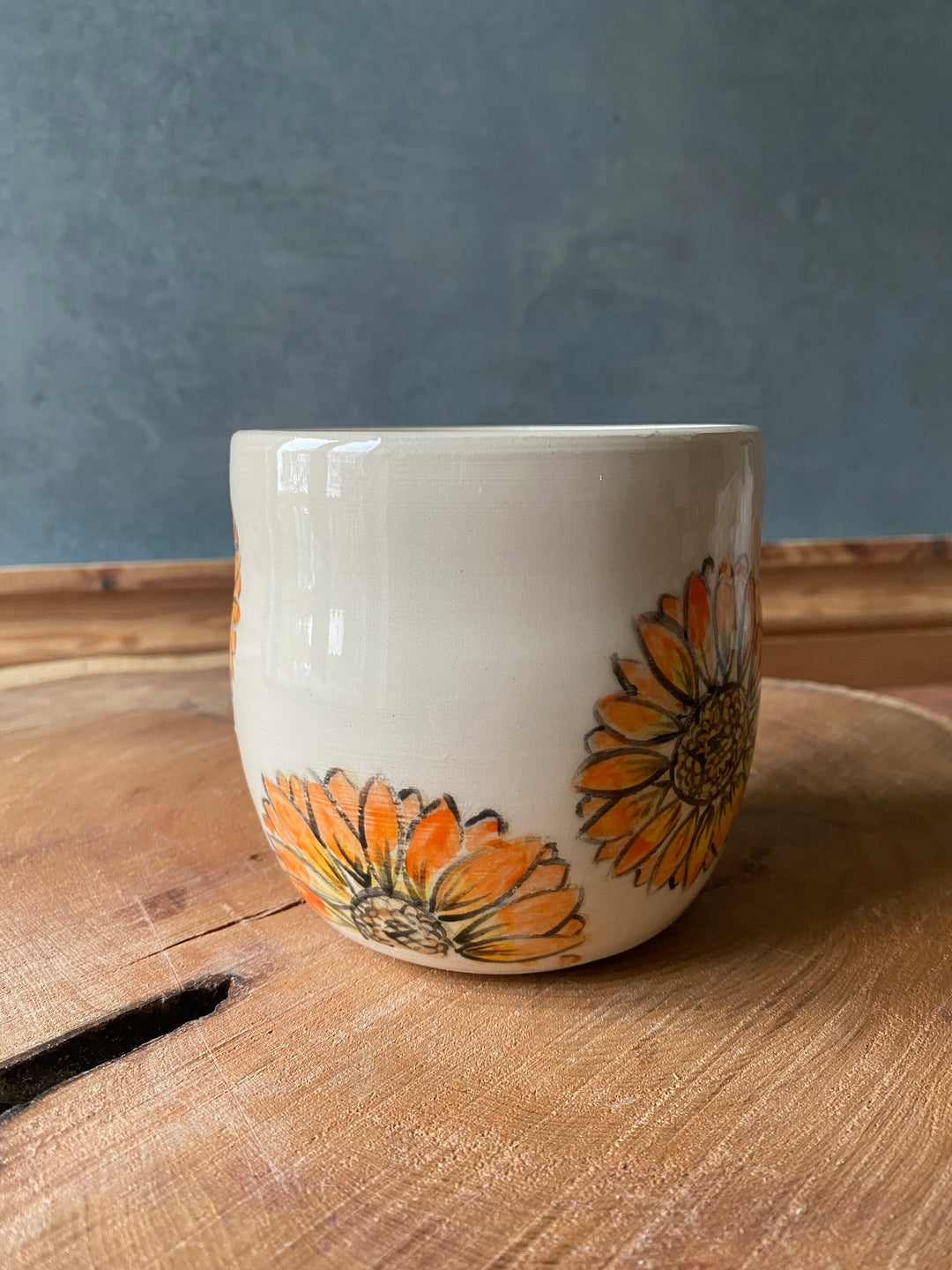 Ceramic cup with floral design on a wooden surface