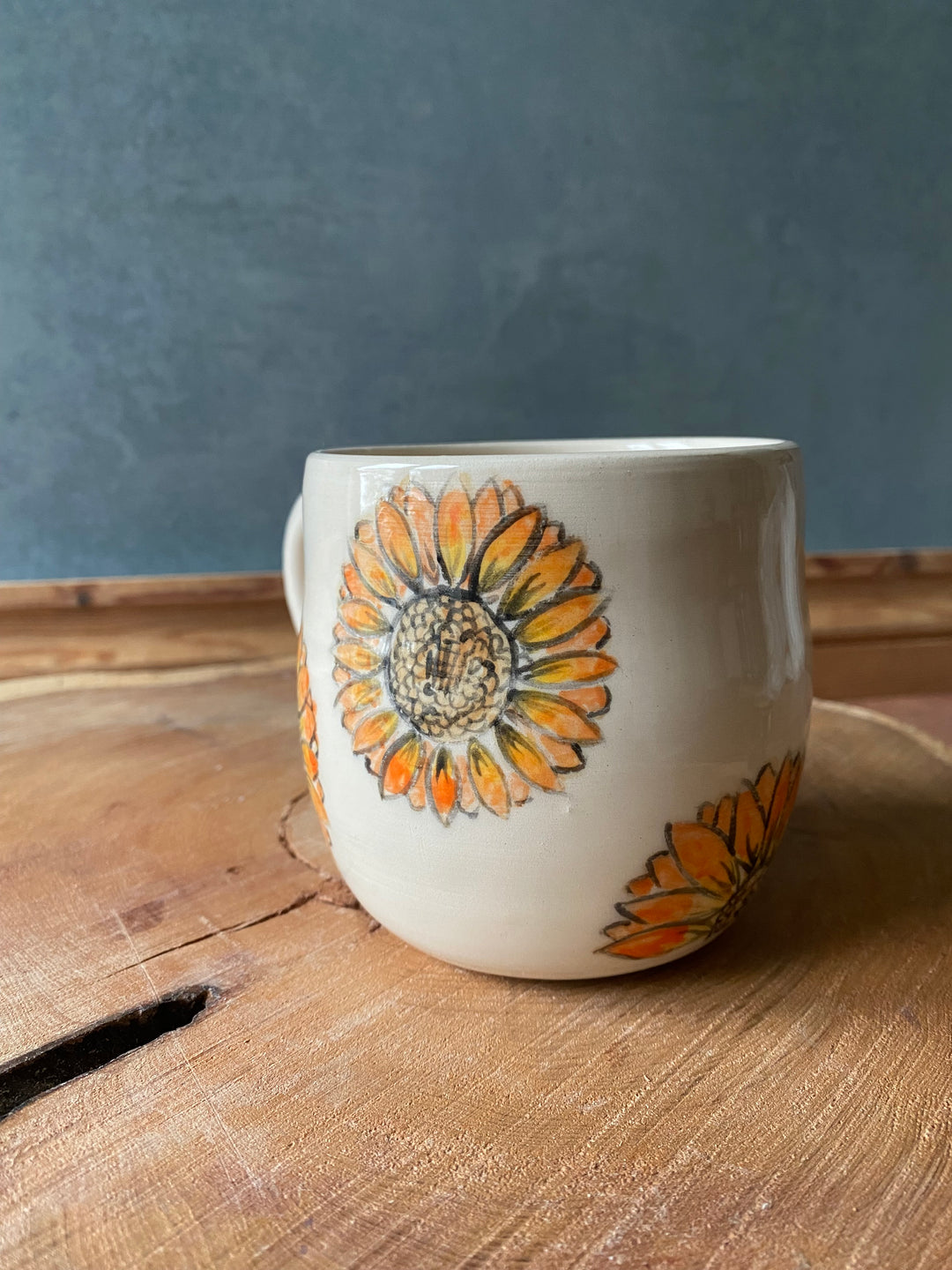 Ceramic container with floral design on a wooden surface