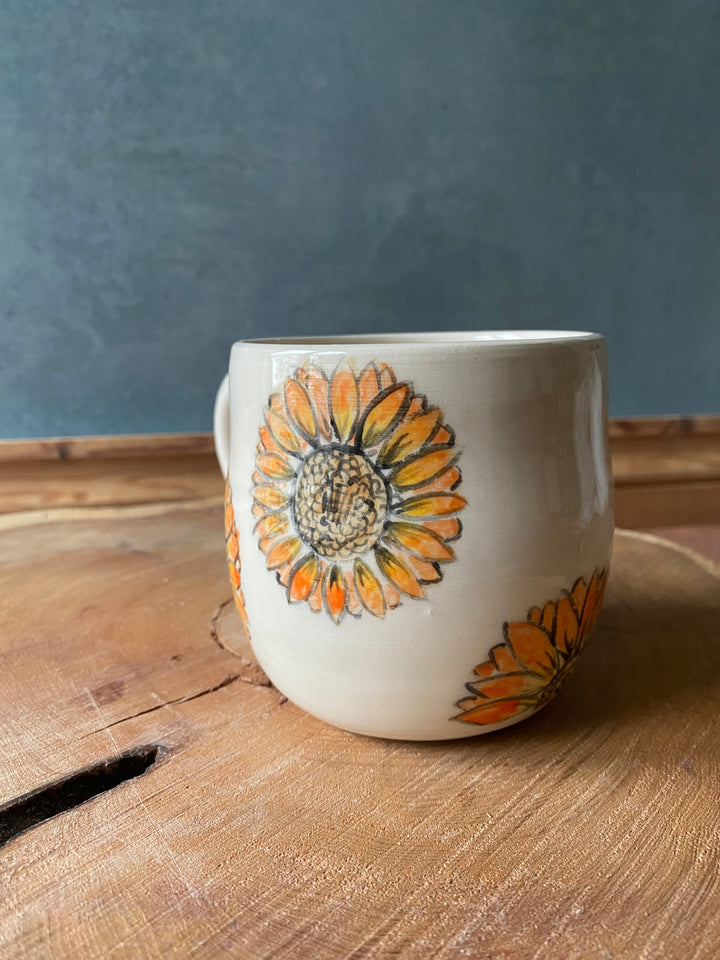 Ceramic container with floral design on a wooden surface