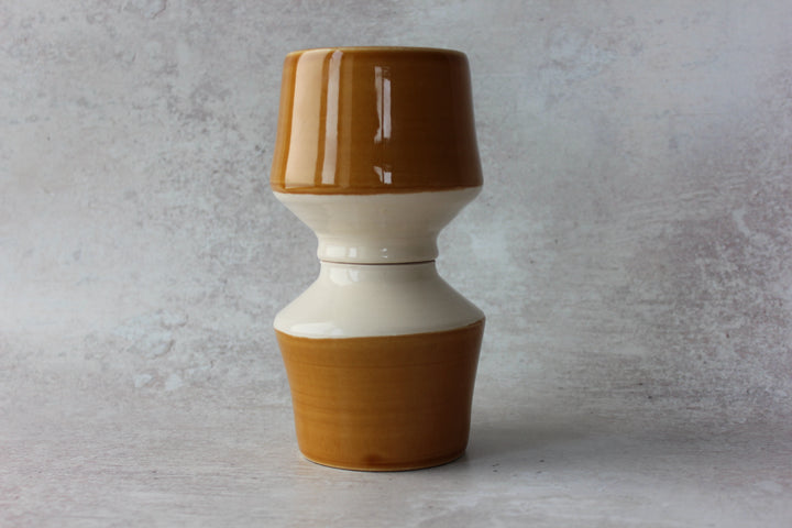 Honey caramel ceramic pedestal mug showing clear interior glaze and trimmed base