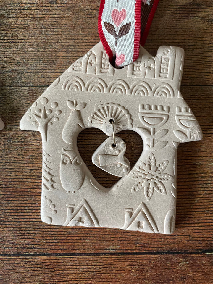 Decorative ceramic tile with heart design on a wooden surface