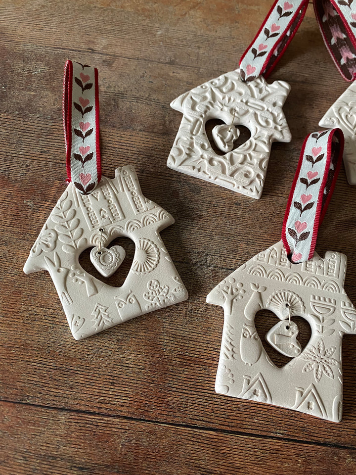 Decorative ceramic ornaments with heart designs on a wooden surface