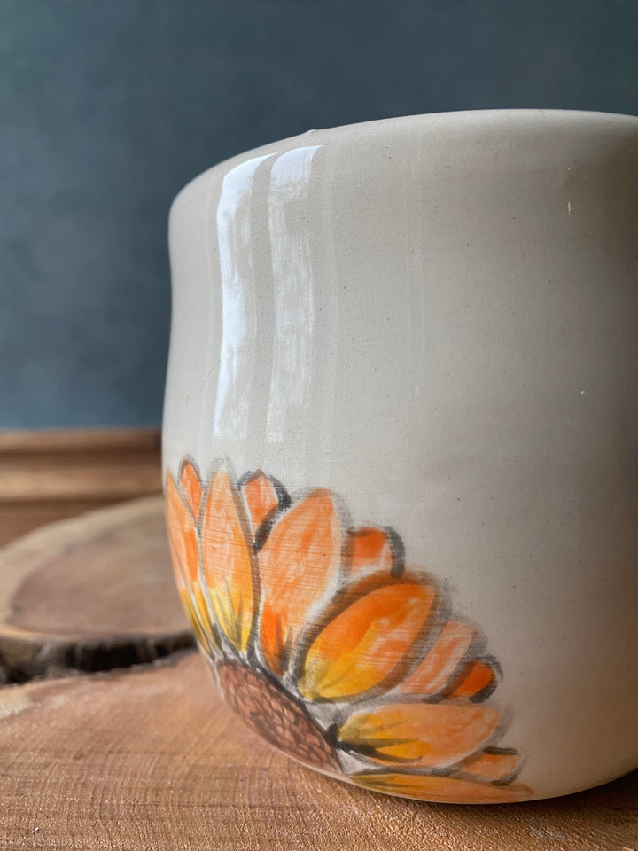 Ceramic vase with a butterfly design on a textured surface