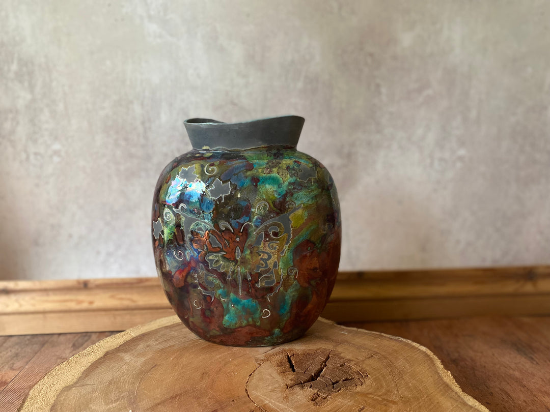 Decorative vase with multicolored patterns on a wooden surface