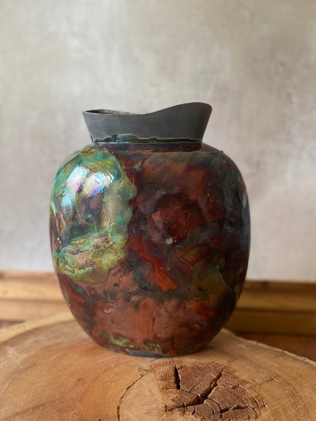 Decorative ceramic vase with a textured surface on a wooden surface