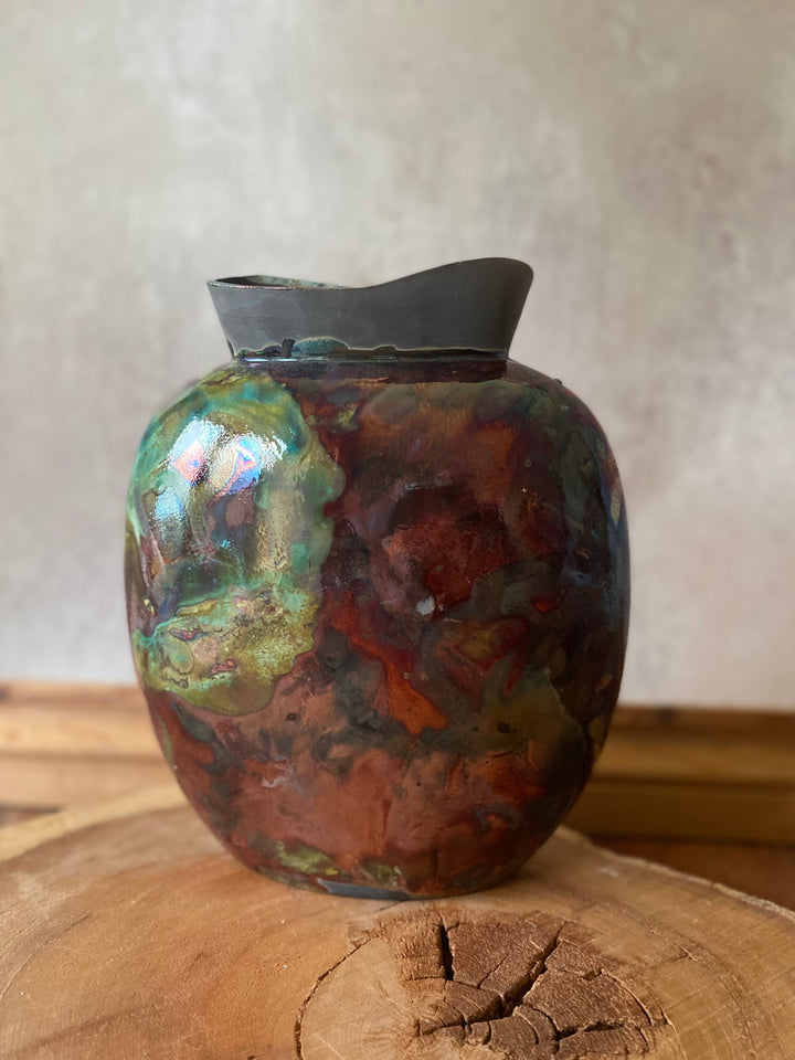 Decorative ceramic vase with a textured surface on a wooden surface