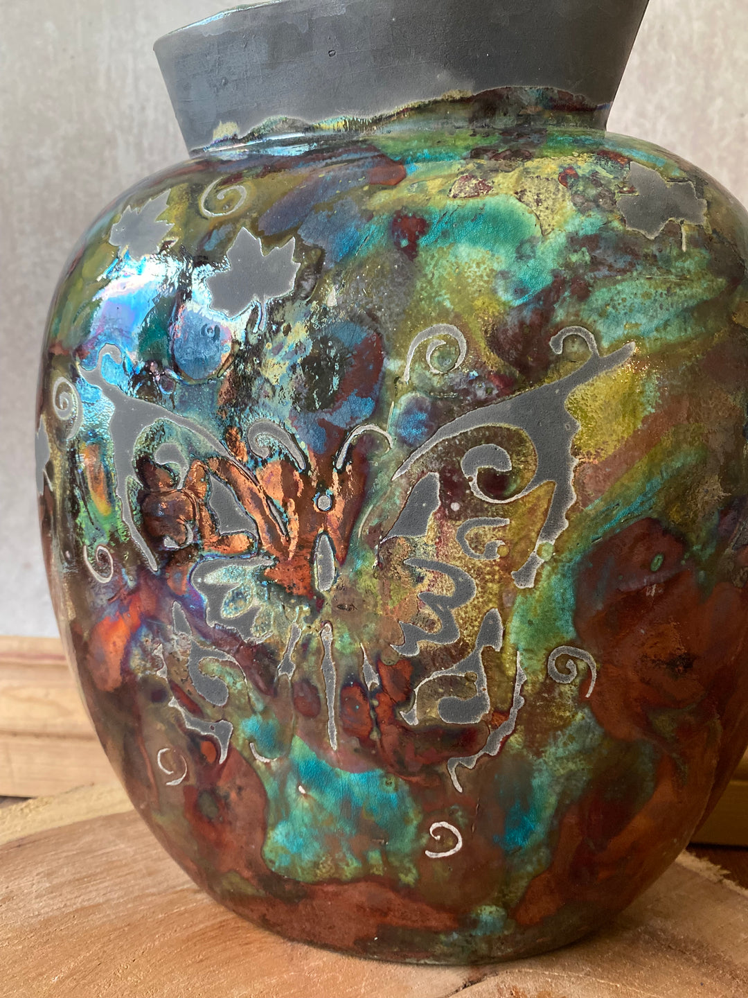 Decorative object with intricate patterns and colors on a wooden surface