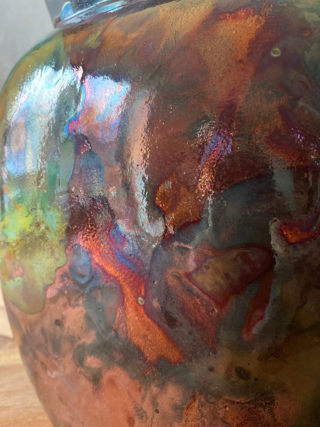 Close-up of a glass bowl with iridescent, multicolored surface