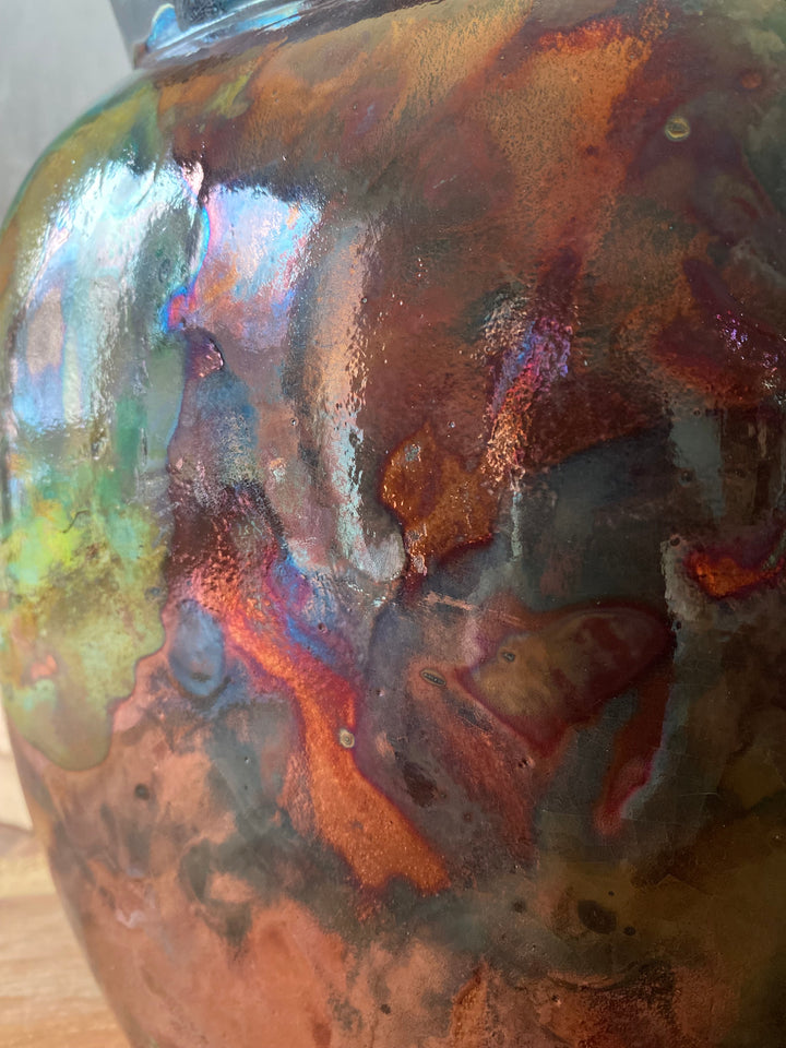 Close-up of a glass bowl with iridescent, multicolored surface