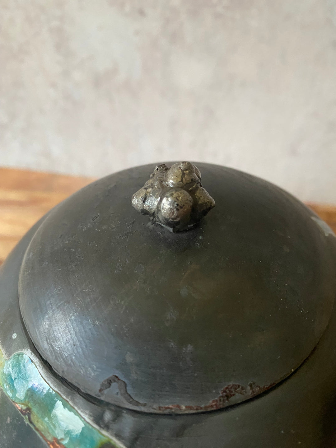 Close-up of a metal object with a bolt on a neutral background