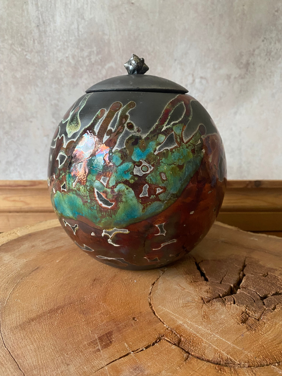 Decorative glass ornament with intricate patterns on a wooden surface