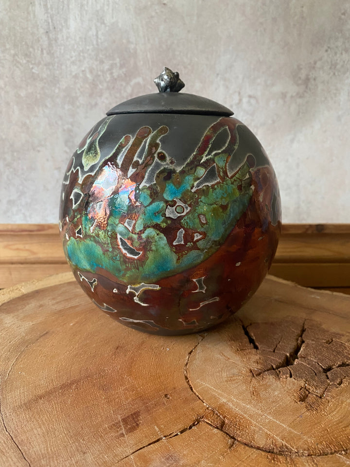 Decorative glass ornament with intricate patterns on a wooden surface