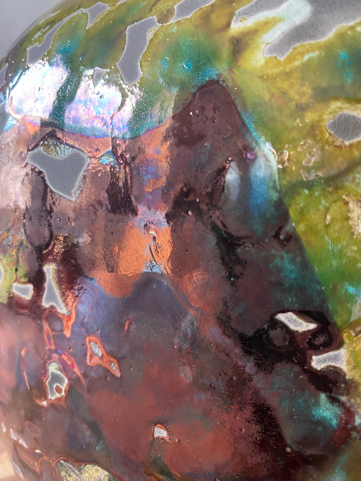 Close-up of a textured surface with metallic and earthy tones