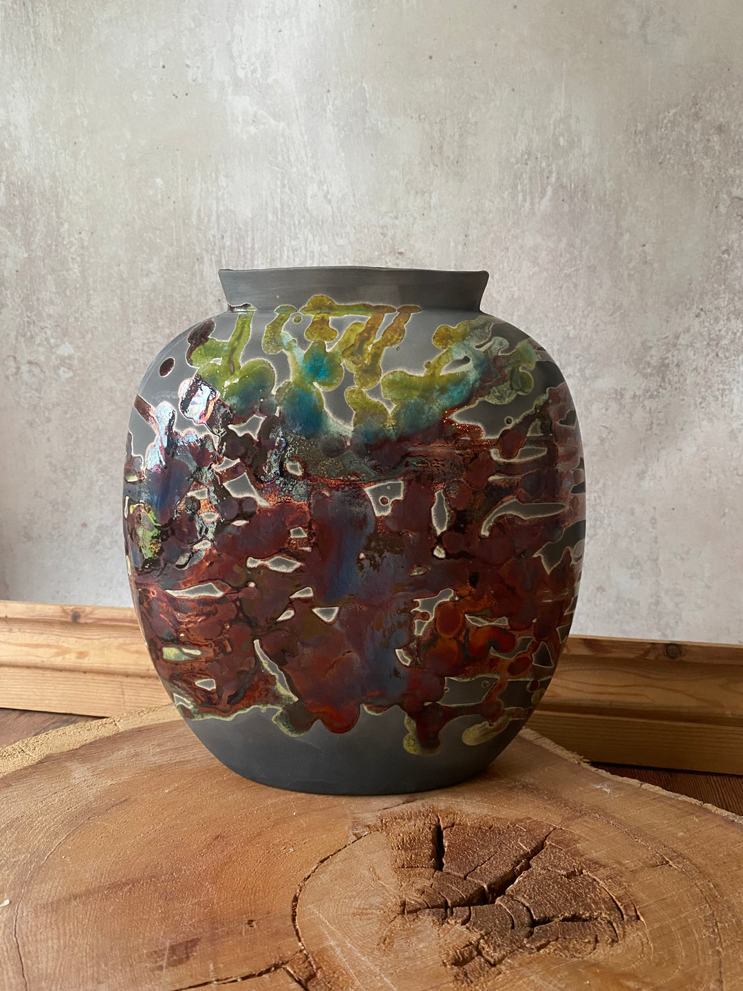 Decorative wall piece with multicolored pattern on a textured surface
