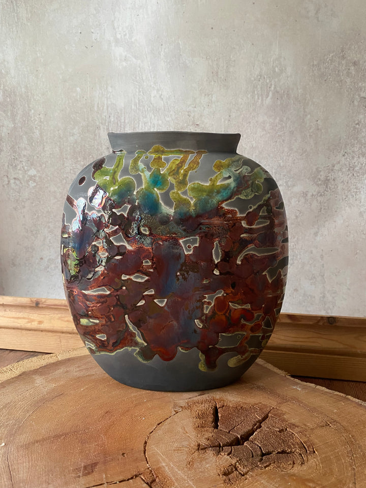 Decorative wall piece with multicolored pattern on a textured surface